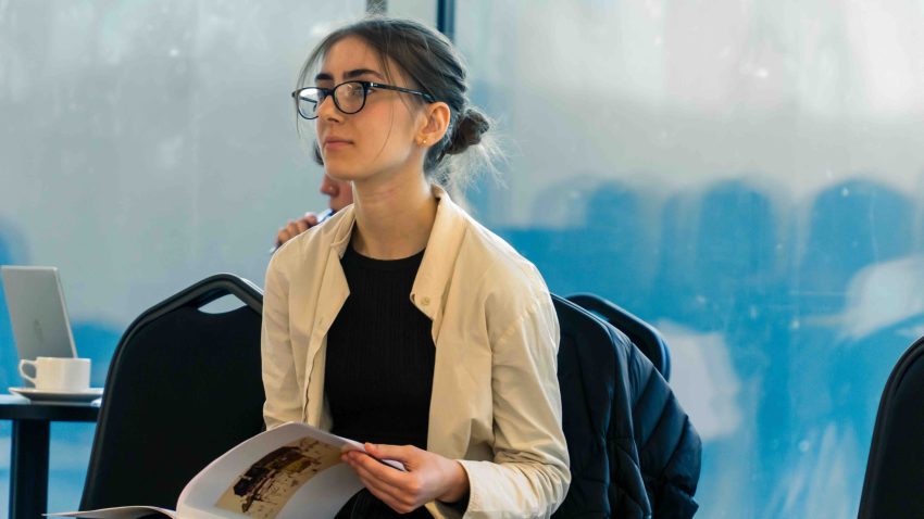 Woman holds booklet in her hands.