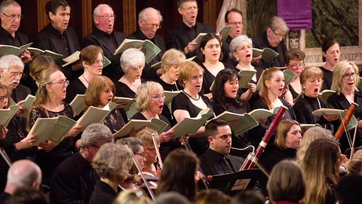 A choir perform in rows.