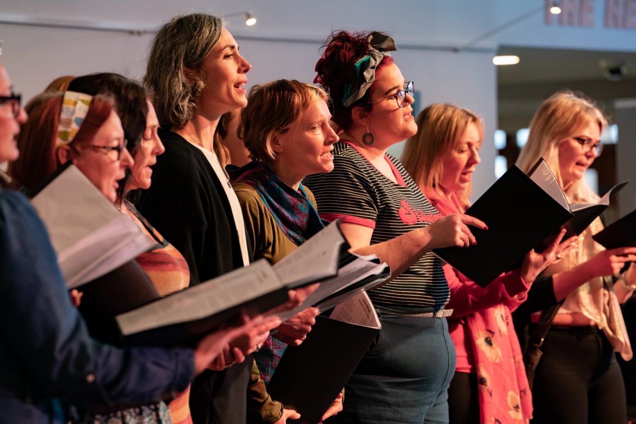 A casually dressed choir singing