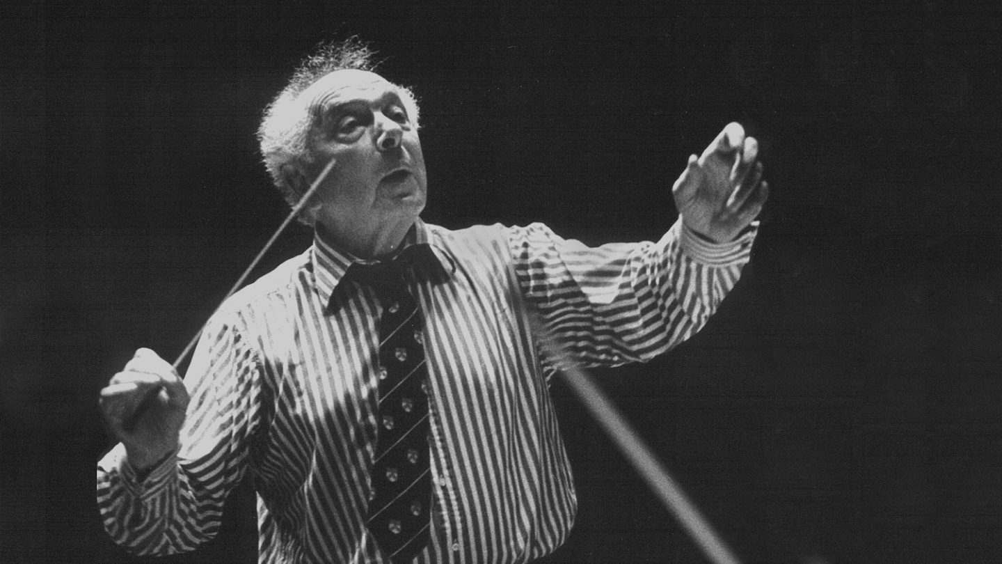 And old black and white photo of Harry Blech conducting