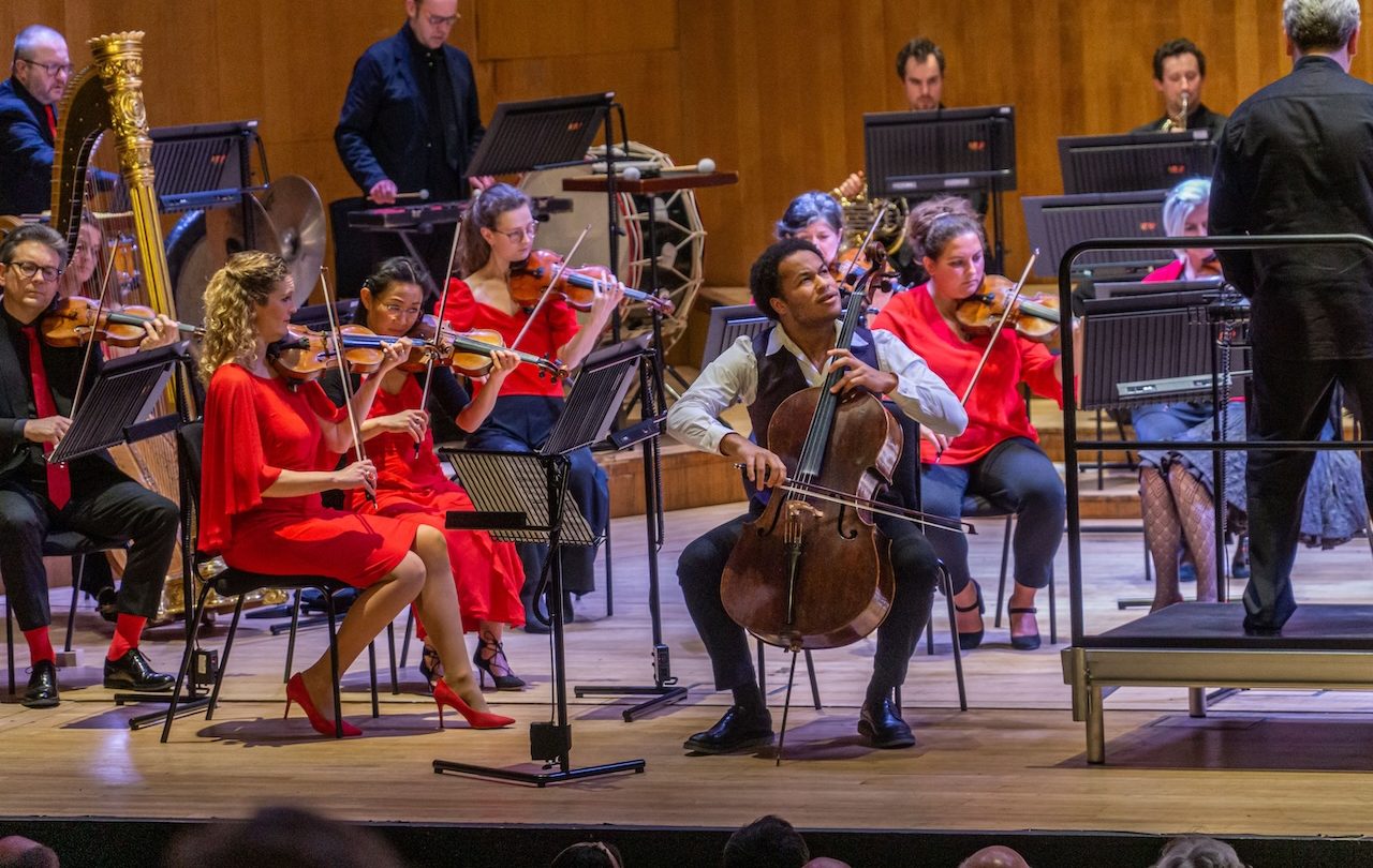 A man expressively plays the cello.