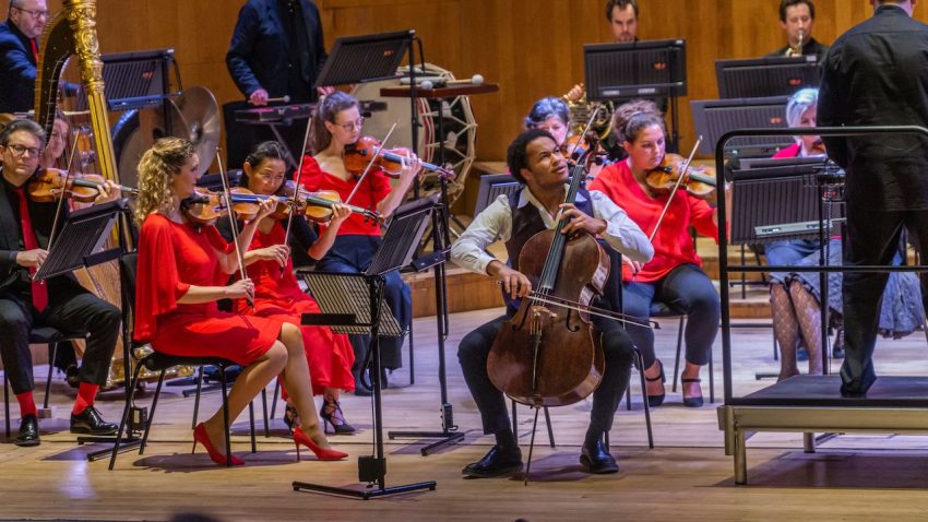 A man expressively plays the cello.